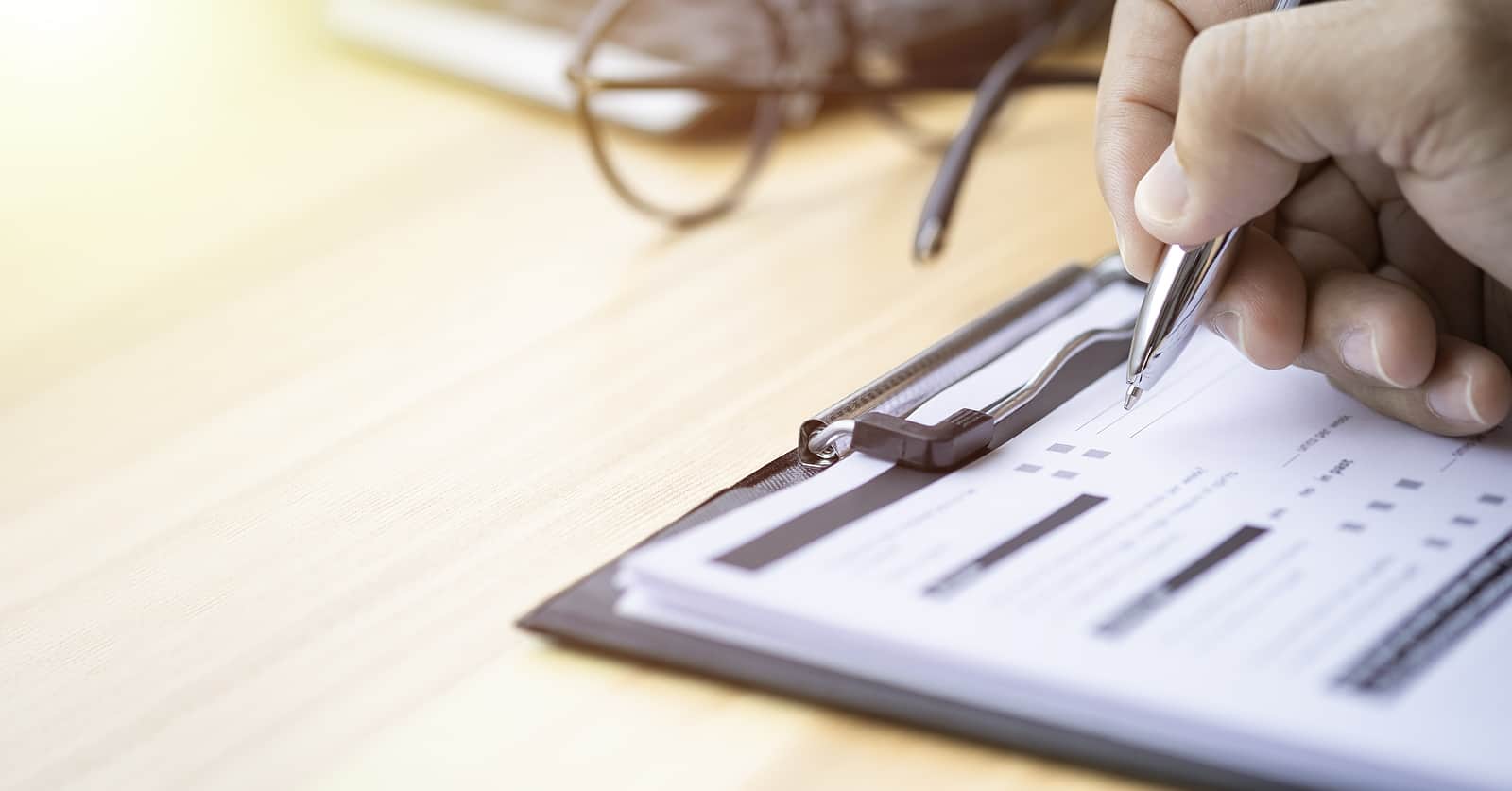 Hand Using Writing Pen With Questionnaire Or Paperwork Survey Qu