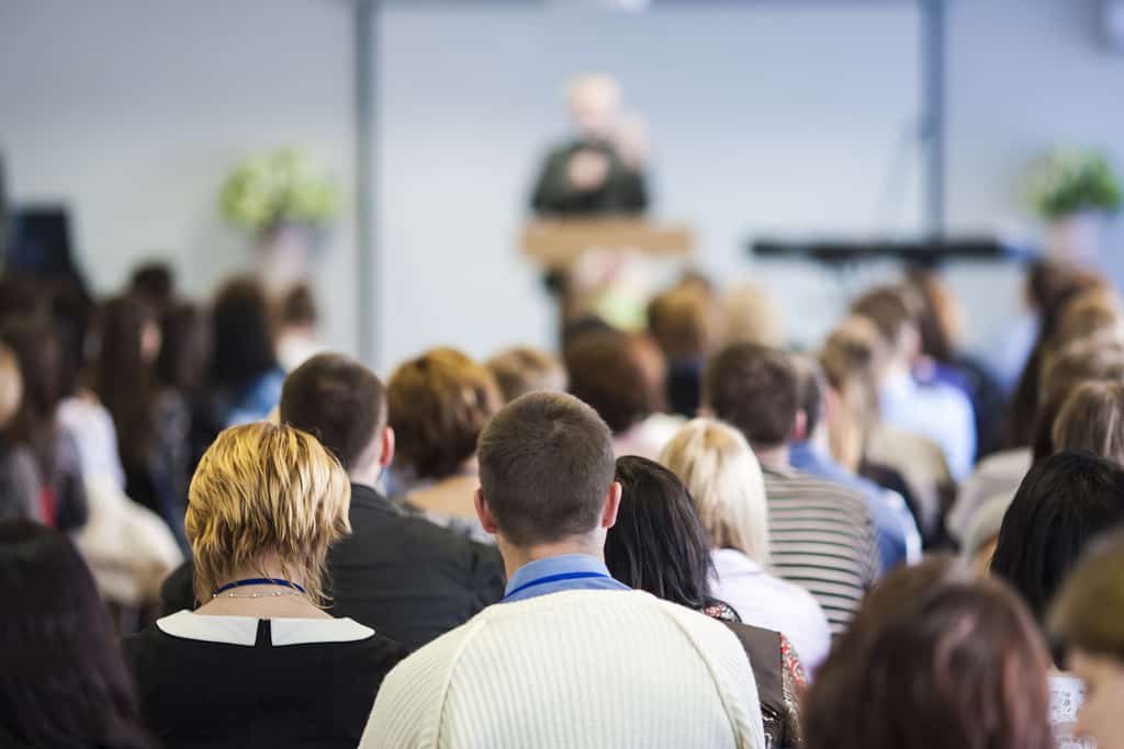 Conferences Concept. Male Lecturer Speaking In Front Of The Audi